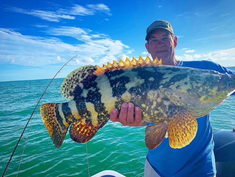 Warren from Wisconsin with a nice grouper, with Capt. Christian Sommer.