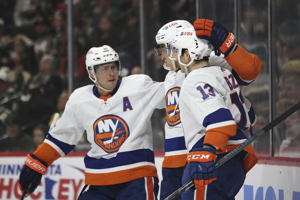 New York Islanders' Mathew Barzal (13) celebrates with teammates after scoring a goal against the Minnesota Wild during the second period of an NHL hockey game Sunday, Nov. 7, 2021, in St. Paul, Minn. (AP Photo/Stacy Bengs)