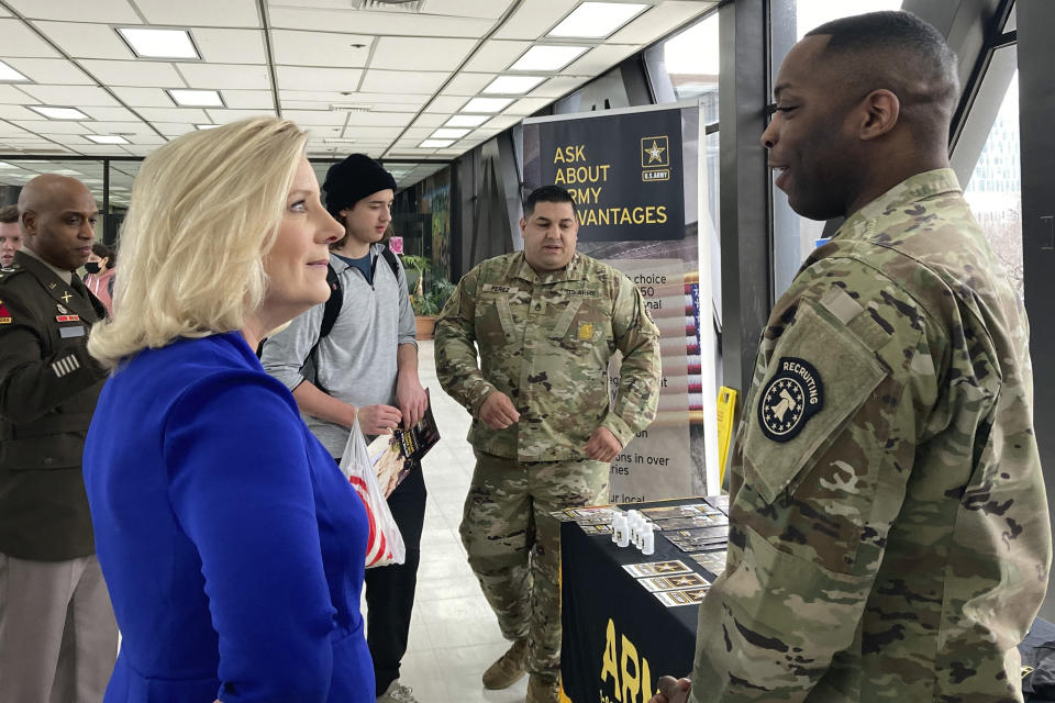 Army Secretary Christine Wormuth stops at an Army recruiting display after a speech to students at the Whitney M. Young Magnet High School in Chicago, on Feb. 14, 2023. Army recruiters are struggling to meet enlistment goals, and they say one of their biggest hurdles is getting back into high schools so they can meet students one on one. During three days of back-to-back meetings across Chicago last month, Wormuth met with students, school leaders, college heads, recruiters and an array of young people involved in ROTC or JROTC programs. (AP Photo/Lolita Baldor)