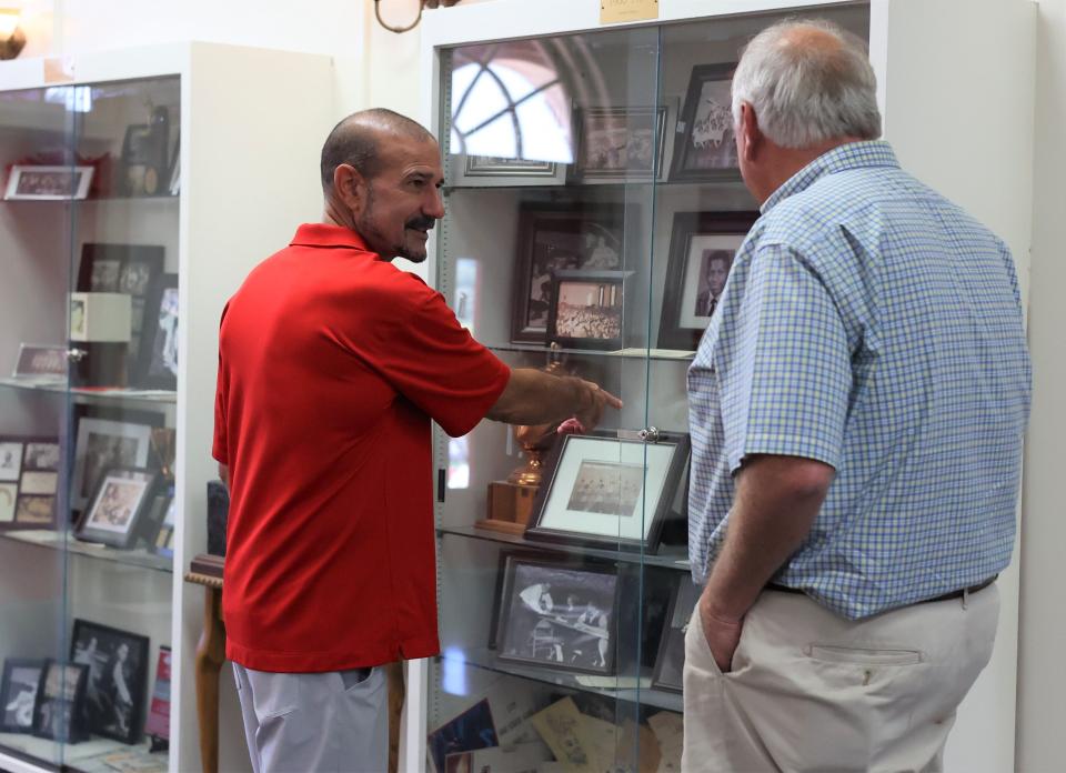 Leon County Schools Superintendent Rocky Hanna points out a picture of his father in a display case at Leon High School at a reunion for the class of 1951 Saturday, Sept. 17, 2022.