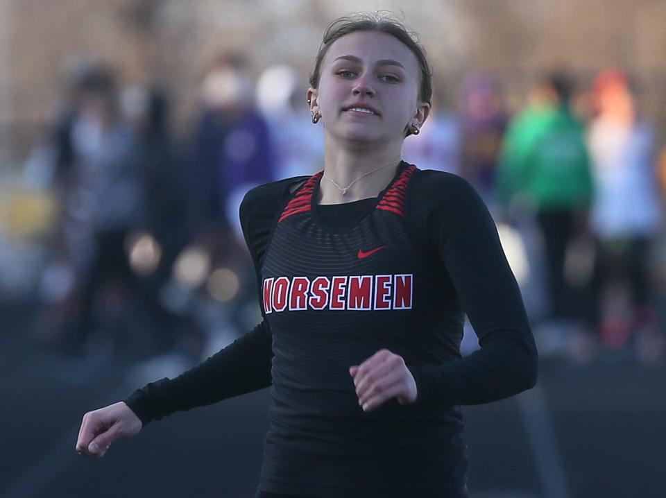 Roland-Story's Kamryn Lande finishes the girls 100-meter desh in the Nevada Co-Ed track & Field at Cubs Stadium on thursday, April 4, 2024, in Nevada, Iowa.