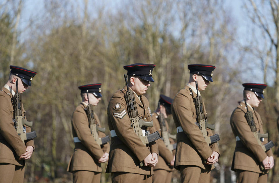 Members of the Armed Forces at the funeral of Captain Tom Moore at Bedford Crematorium, in Bedford, England, Saturday, Feb. 27, 2021. Tom Moore, the 100-year-old World War II veteran who captivated the British public in the early days of the coronavirus pandemic with his fundraising efforts died, Tuesday Feb. 2, 2021. (Joe Giddens/Pool Photo via AP)