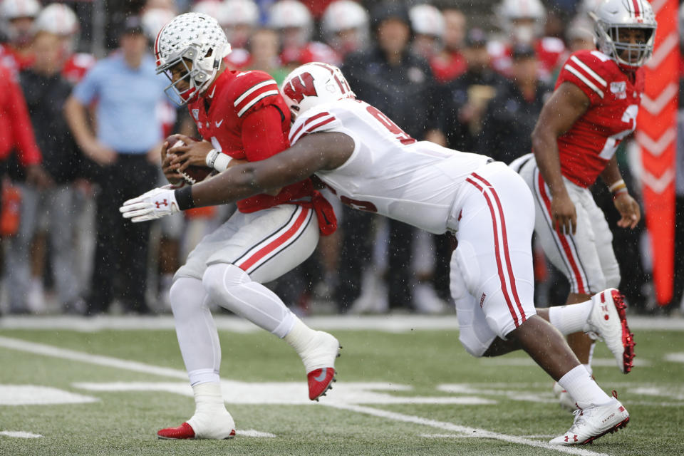 Wisconsin defensive lineman Keeanu Benton, right, sacks Ohio State quarterback Justin Fields during the first half of an NCAA college football game Saturday, Oct. 26, 2019, in Columbus, Ohio. (AP Photo/Jay LaPrete)