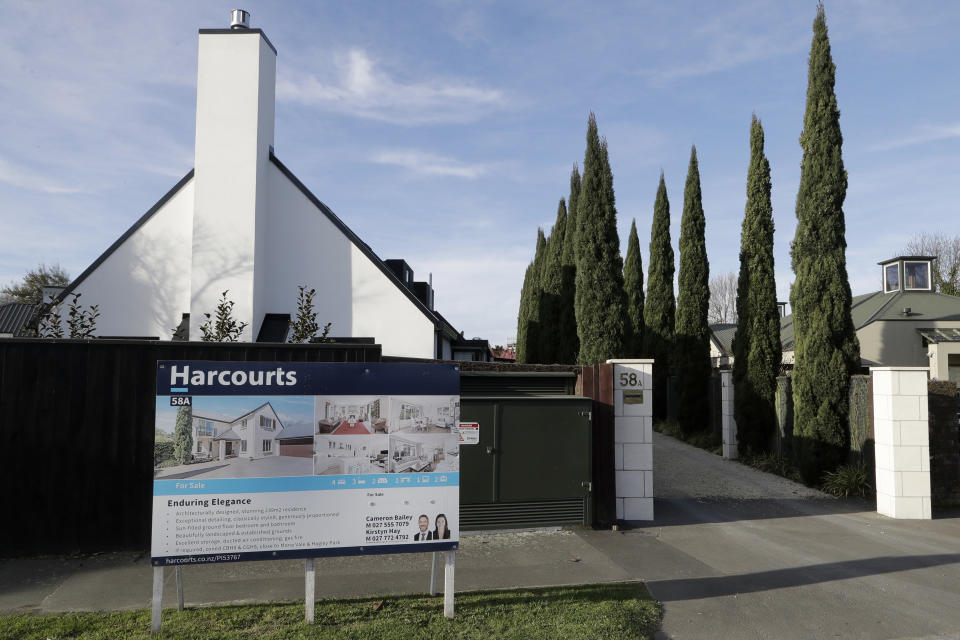 FILE - In this Aug. 13, 2018, file photo a house is pictured for sale in Christchurch, New Zealand. New Zealand will spend billions of dollars to encourage more home building and will also remove some tax breaks for speculators as it tries to slow skyrocketing house prices. The government on Tuesday announced a series of new measures to address what Prime Minister Jacinda Ardern is describing as a crisis.(AP Photo/Mark Baker, File)