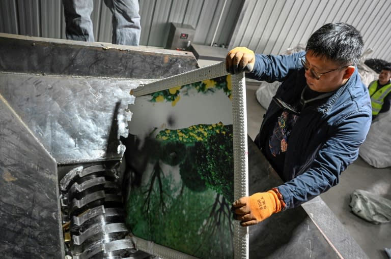 At a dusty warehouse in China shreds photos of beaming bridal couples turning stories of heartbreak into a source of electricity (Jade GAO)