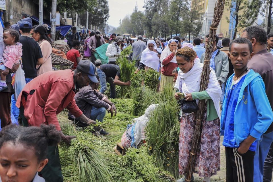 People shop at Sholla Market, the day before the Ethiopian New Year, in Addis Ababa, Ethiopia Saturday, Sept. 10, 2022. Once home to one of Africa's fastest growing economies, Ethiopia is struggling as the war in its Tigray region has reignited and Ethiopians are experiencing the highest inflation in a decade, foreign exchange restrictions and mounting debt amid reports of massive government spending on the war effort. (AP Photo)