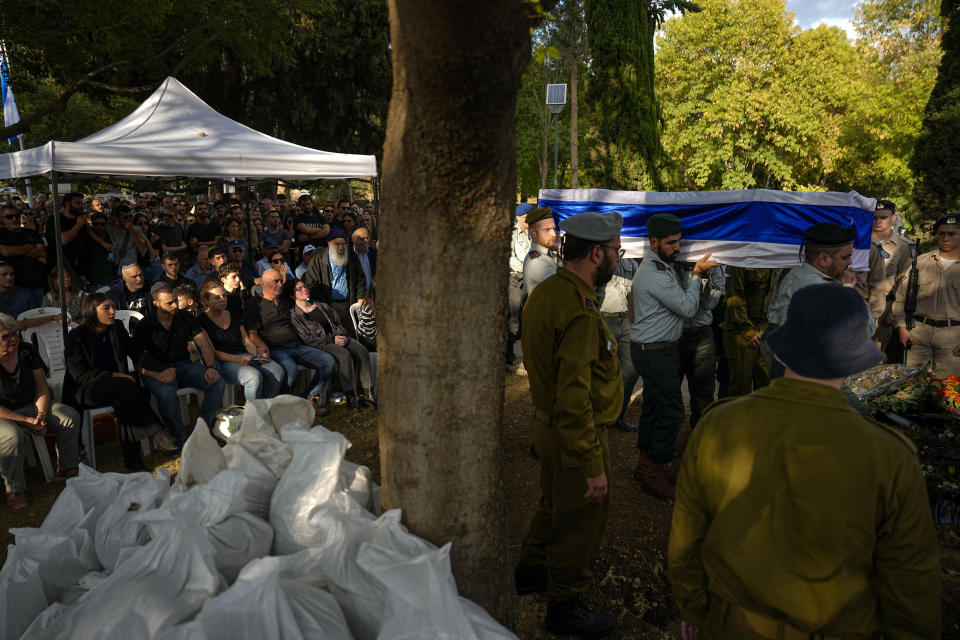 Israeli military officers carry the flagged coffin of Israeli reserve soldier captain Omri Yosef David during his funeral in Carmiel, northern Israel, Wednesday, Nov. 15, 2023. David, 27, was killed during a military ground operation in the Gaza Strip. (AP Photo/Ariel Schalit)