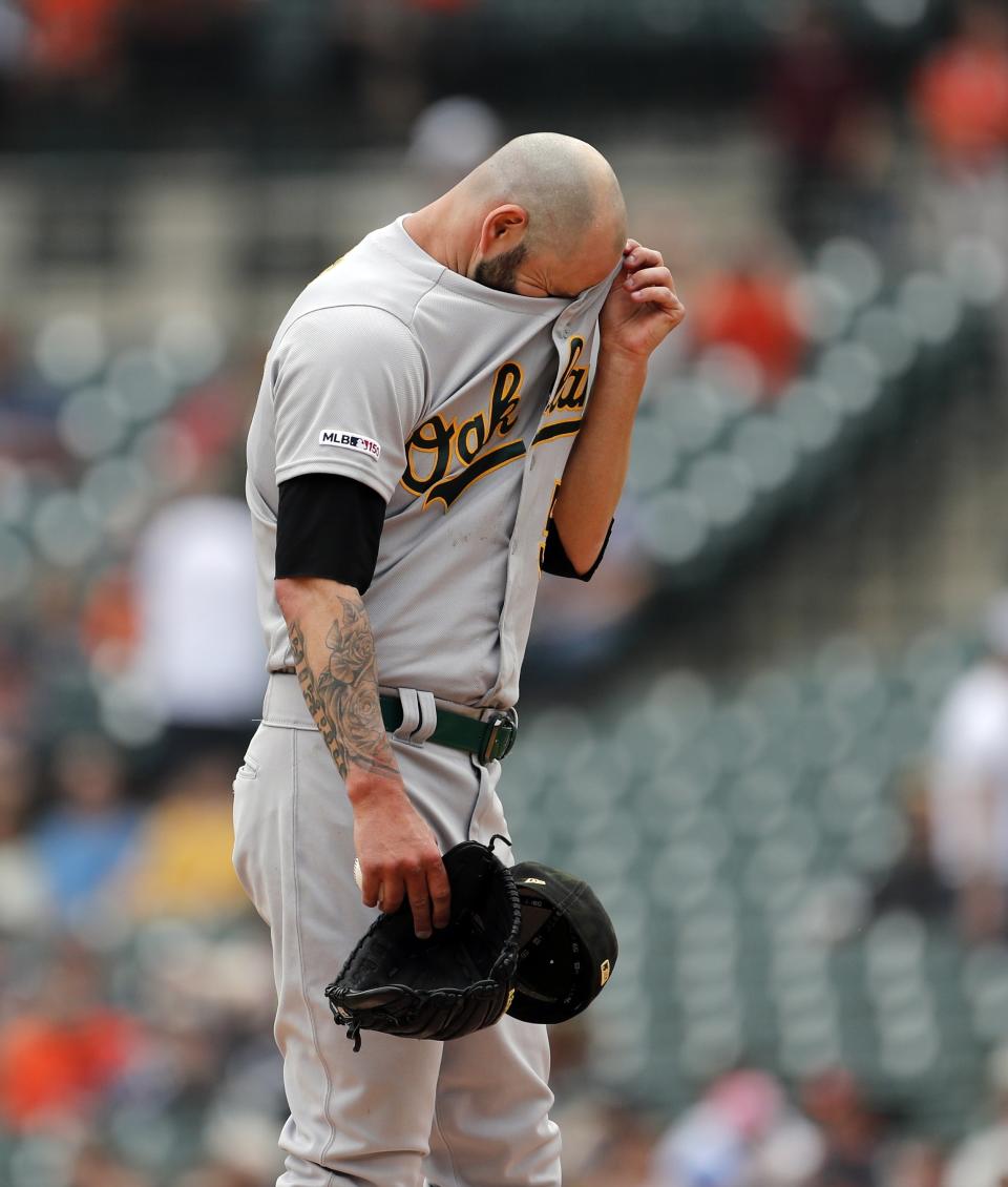 Oakland Athletics starting pitcher Mike Fiers wipes his forehead during the first inning of a baseball game against the Detroit Tigers, Sunday, May 19, 2019, in Detroit. (AP Photo/Carlos Osorio)