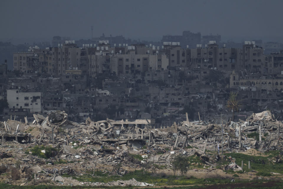 Destroyed buildings stand in the Gaza Strip as seen from southern Israel, Thursday, Feb. 15, 2024. (AP Photo/Leo Correa)