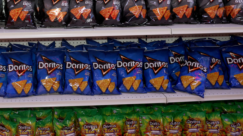 selection of doritos on shelf at grocery store