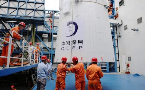 Loading the Queqiao ("Magpie Bridge") satellite at the Xichang launch centr - Credit: AFP