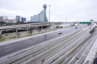 A part of the city skyline is seen along the IH 30 and IH 35 interchange as drivers navigate slushy and icy road condition, Wednesday, Feb. 1, 2023, in Dallas. (AP Photo/Tony Gutierrez)