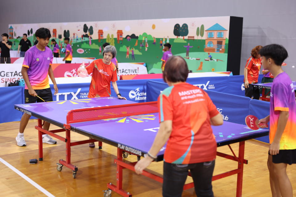 Seniors and youths trying out TTX, a new form of table tennis suitable for outdoor play, at the launch of the ActiveX initiative. (PHOTO: Sport Singapore)