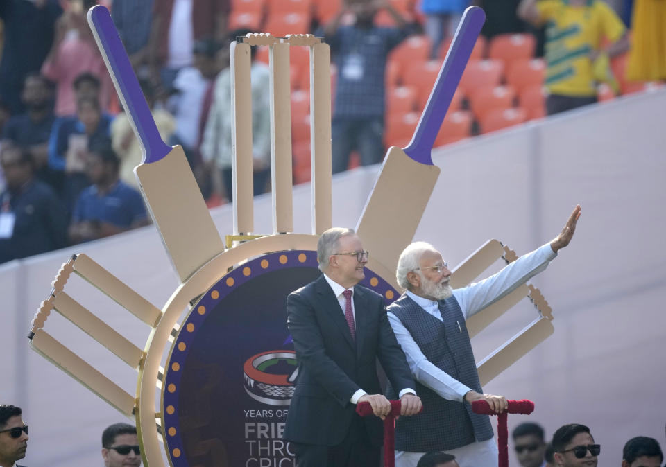 Indian Prime Minister Narendra Modi with his Australian counterpart Anthony Albanese wave as they arrive in the stadium to watch fourth cricket test match between India and Australia in Ahmedabad, India, Thursday, March 9, 2023. (AP Photo/Ajit Solanki)