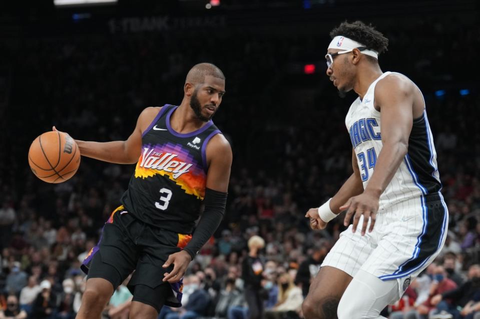 Chris Paul handles the ball in front of Wendell Carter