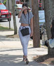 <p>Jenner was definitely keeping cool for the summer in a simple white maxi skirt and casual gray T-shirt that looks like she cut and cropped herself.</p>