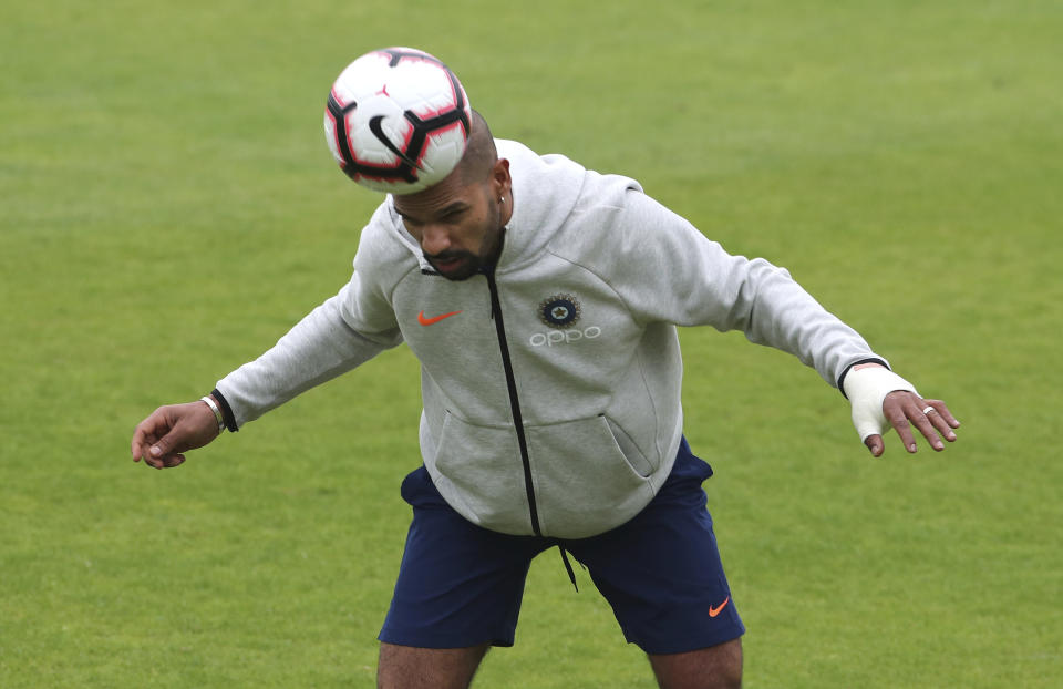 India's Shikhar Dhawan heads the soccer ball during a training session ahead of their Cricket World Cup match against Afghanistan at the Hampshire Bowl in Southampton, England, Wednesday, June 19, 2019. (AP Photo/Aijaz Rahi)