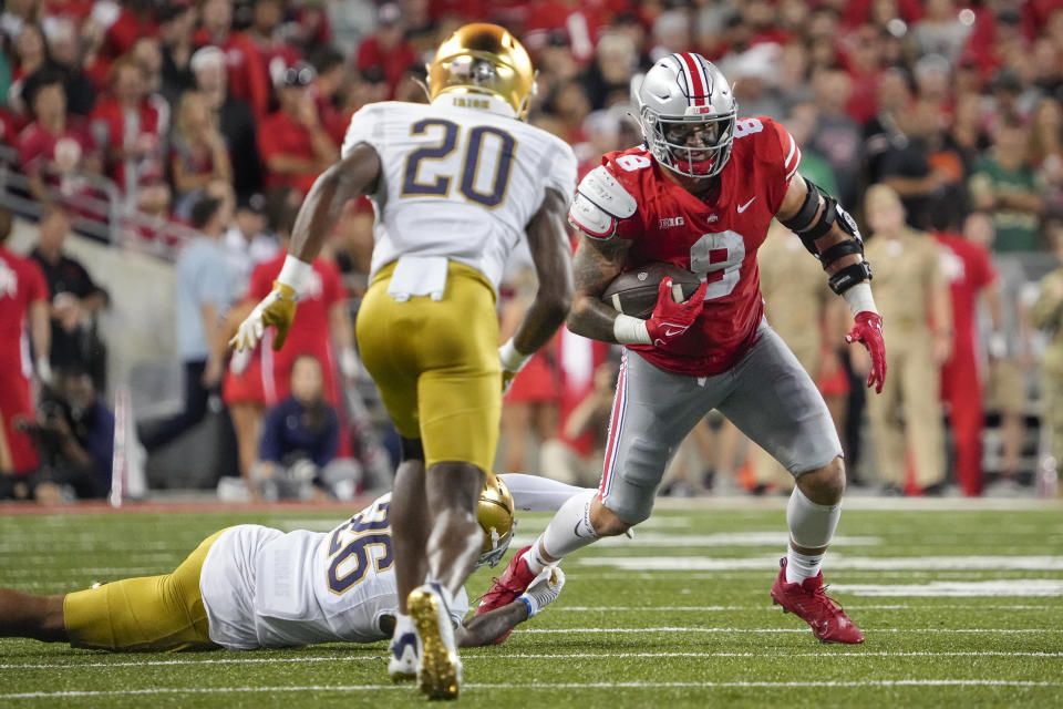 Sep 3, 2022; Columbus, Ohio, USA; Ohio State Buckeyes tight end <a class="link " href="https://sports.yahoo.com/ncaaf/players/303607" data-i13n="sec:content-canvas;subsec:anchor_text;elm:context_link" data-ylk="slk:Cade Stover;sec:content-canvas;subsec:anchor_text;elm:context_link;itc:0">Cade Stover</a> (8) tries to elude tackle by Notre Dame Fighting Irish wide receiver Chase Dixon (26) and cornerback <a class="link " href="https://sports.yahoo.com/ncaaf/players/339830" data-i13n="sec:content-canvas;subsec:anchor_text;elm:context_link" data-ylk="slk:Benjamin Morrison;sec:content-canvas;subsec:anchor_text;elm:context_link;itc:0">Benjamin Morrison</a> (20) during the NCAA football game at Ohio Stadium. Mandatory Credit: Adam Cairns-USA TODAY Sports