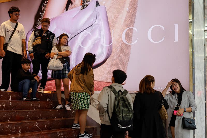 People queue outside a Gucci store in Tsim Sha Tsui, a bustling shopping hotspot, in Hong Kong