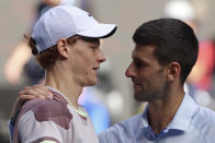 Jannik Sinner, left, of Italy is congratulated by Novak Djokovic of Serbia following their semifinal at the Australian Open tennis championships at Melbourne Park, Melbourne, Australia, Friday, Jan. 26, 2024. (AP Photo/Asanka Brendon Ratnayake)