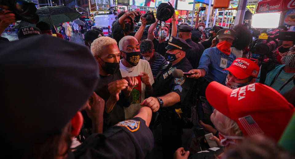 A small group of Trump supporters are confronted with anti-racism demonstrators at Times Square. Source: Getty