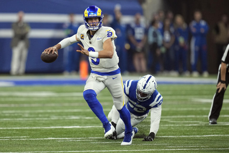 Los Angeles Rams quarterback Matthew Stafford scrambles as Indianapolis Colts linebacker Isaiah Land pressures during the first half of an NFL football game, Sunday, Oct. 1, 2023, in Indianapolis. (AP Photo/Darron Cummings)
