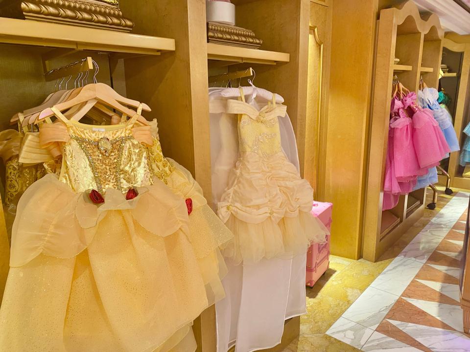 rows of princess dress costumes for sale at bippity boppity boutique in disney world