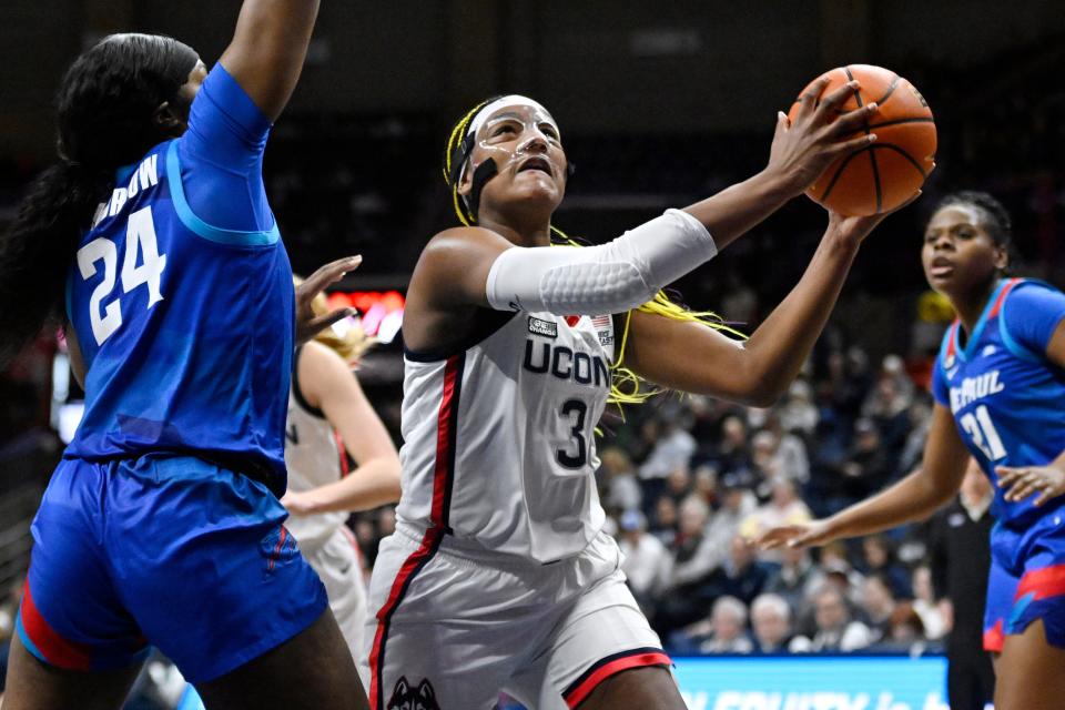 UConn's Aaliyah Edwards (3) drives to the basket as DePaul's Aneesah Morrow (24) defends in the first half of an NCAA college basketball game, Monday, Jan. 23, 2023, in Storrs, Conn. (AP Photo/Jessica Hill)