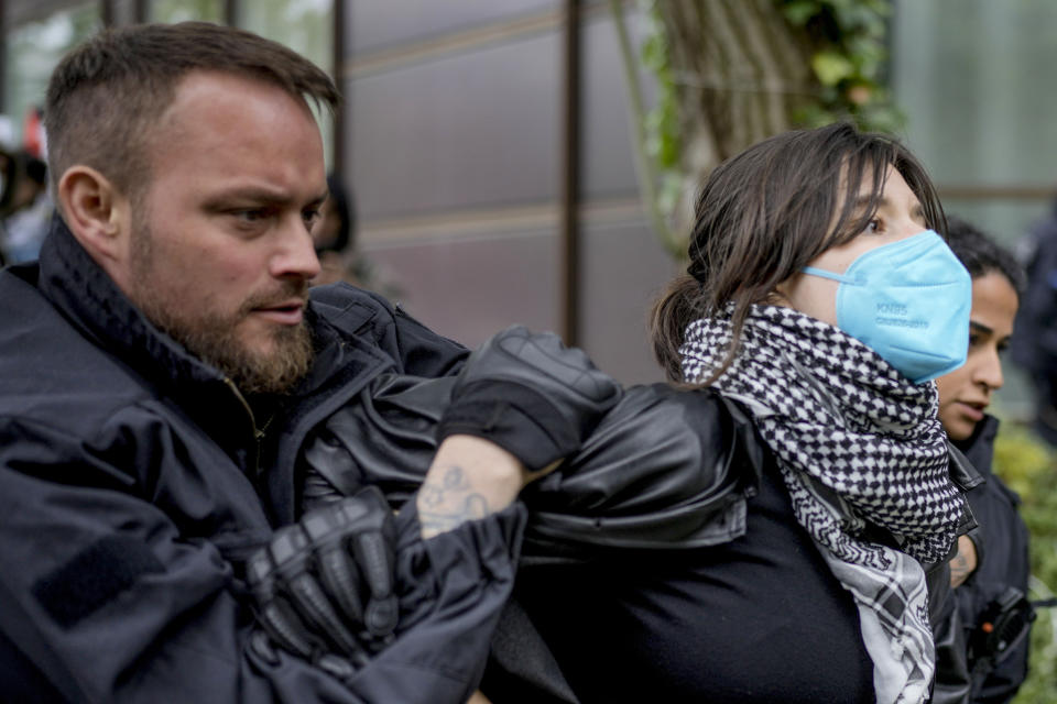 A person is led away by police officers during a pro-Palestinians demonstration by the group "Student Coalition Berlin" in the theater courtyard of the 'Freie Universität Berlin' university in Berlin, Germany, Tuesday, May 7, 2024. Pro-Palestinian activists occupied a courtyard of the Free University in Berlin on Tuesday. (AP Photo/Markus Schreiber)