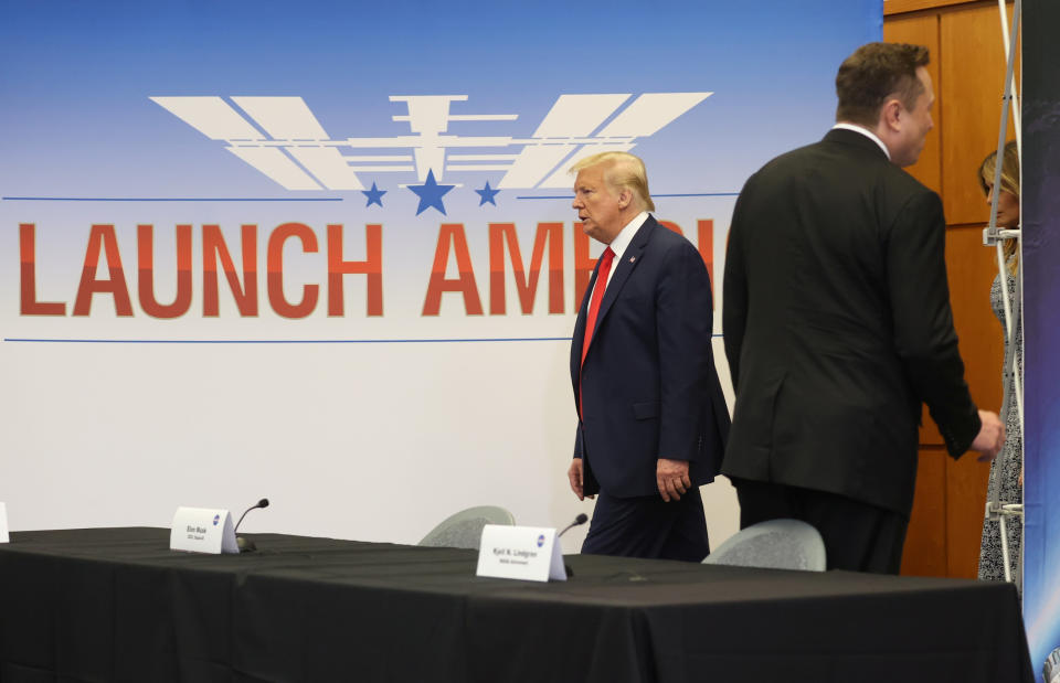 U.S. President Donald Trump passes SpaceX founder and CEO Elon Musk as he arrives with first lady Melania Trump to attend a SpaceX mission briefing before watching the planned launch of a SpaceX Falcon 9 rocket carrying two NASA astronauts to the International Space Station at the Kennedy Space Center in Cape Canaveral, Florida, U.S., May 27, 2020. REUTERS/Jonathan Ernst