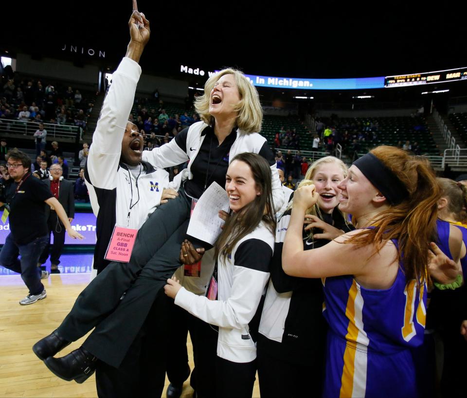 Birmingham Marian assistant coaches Derrick Thomas, left, and Michelle Lindsey carry head coach Mary Cicerone after their 51-37 win over Dewitt in the 2015 Class A girls basketball final.