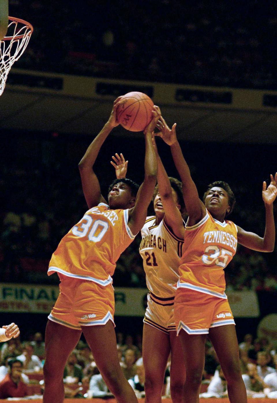 FILE - In this March 27, 1987, file photo, Bridgette Gordon (30) and Melissa McCray (35) of Tennessee double team Shannon Smith (21) of Cal State Long Beach as they go for a rebound during the first half of the NCAA Women's Final four semifinals in Austin, Texas. Bridgette Gordon starred on two of Tennessee's national championship teams and reached the Final Four each of her four seasons with the Lady Volunteers. Now the U.S. Olympic gold medalist is back at her alma mater as an assistant coach trying to help Tennessee regain the prominence it enjoyed during her own playing career. (AP Photo/David Breslauer, File)