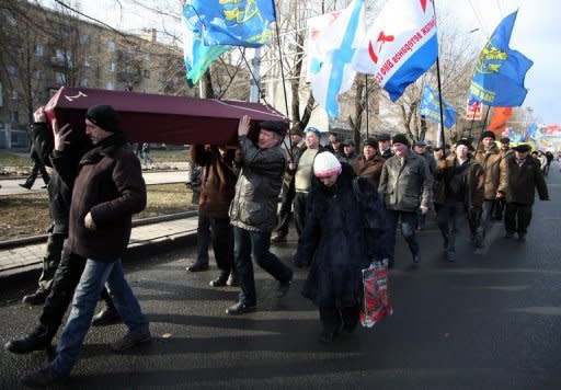 Ukrainian veterans of the Chernobyl nuclear disaster cleanup carry a mock coffin during the symbolic burial of their colleague Gennady Konoplyov during a protest in Donetsk. Ukraine has launched construction of a new shelter to permanently secure the stricken Chernobyl plant as it marks the 26th anniversary of the world's worst nuclear disaster