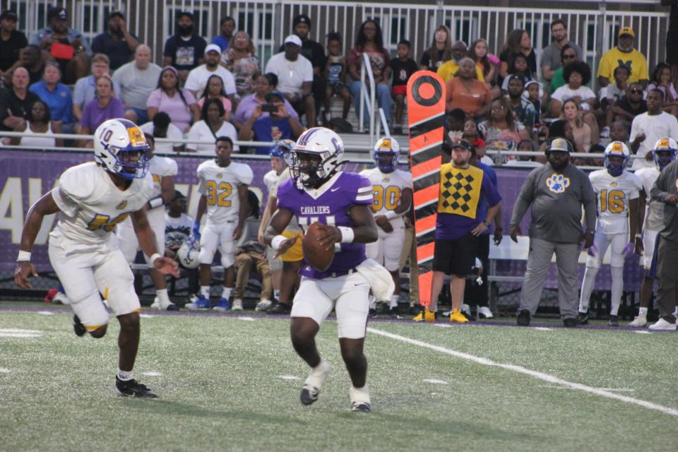 Calvary Day quarterback James Mobley IV looks for a receiver downfield in the Cavs win over Beach on Aug. 16, 2024.