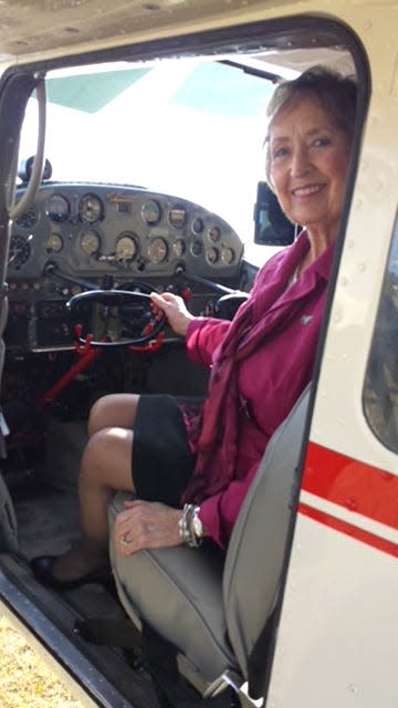 Speaker Susan Reid, in a Cessna 180, like the one her sister piloted solo around the world.