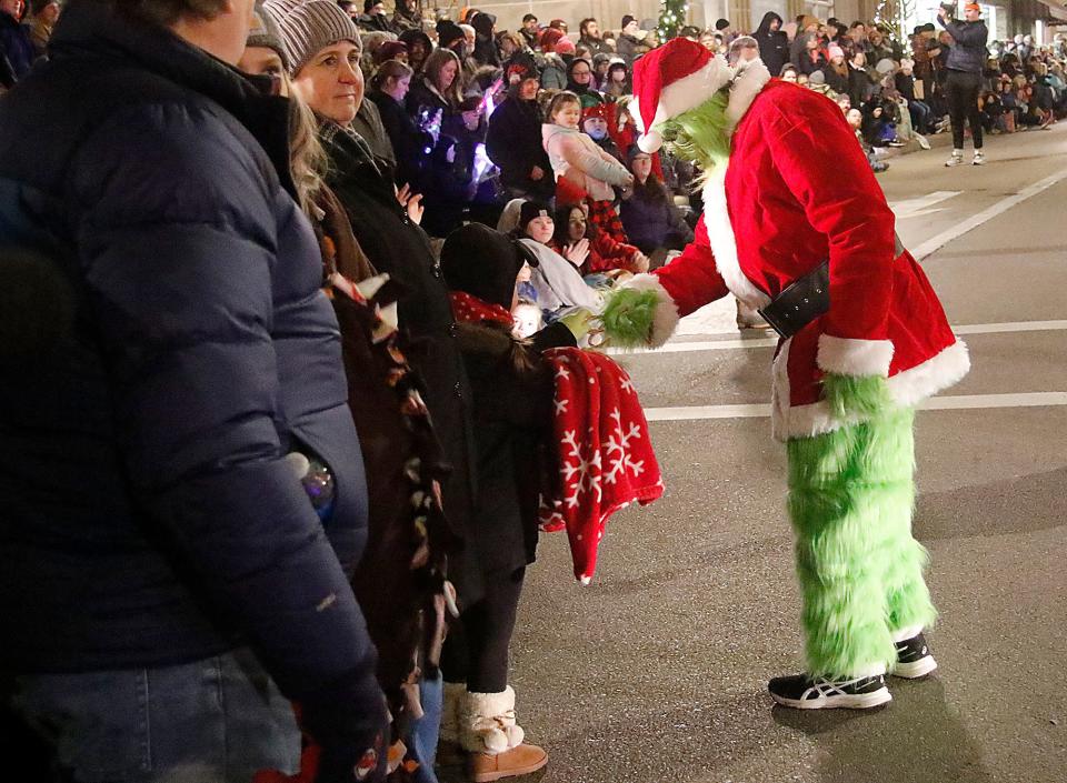 The Grinch greets parade watchers at Ashland's 2021 Christmas parade is seen heading down Claremont Avenue at West Main Street on Saturday, Dec. 4, 2021. TOM E. PUSKAR/TIMES-GAZETTE.COM