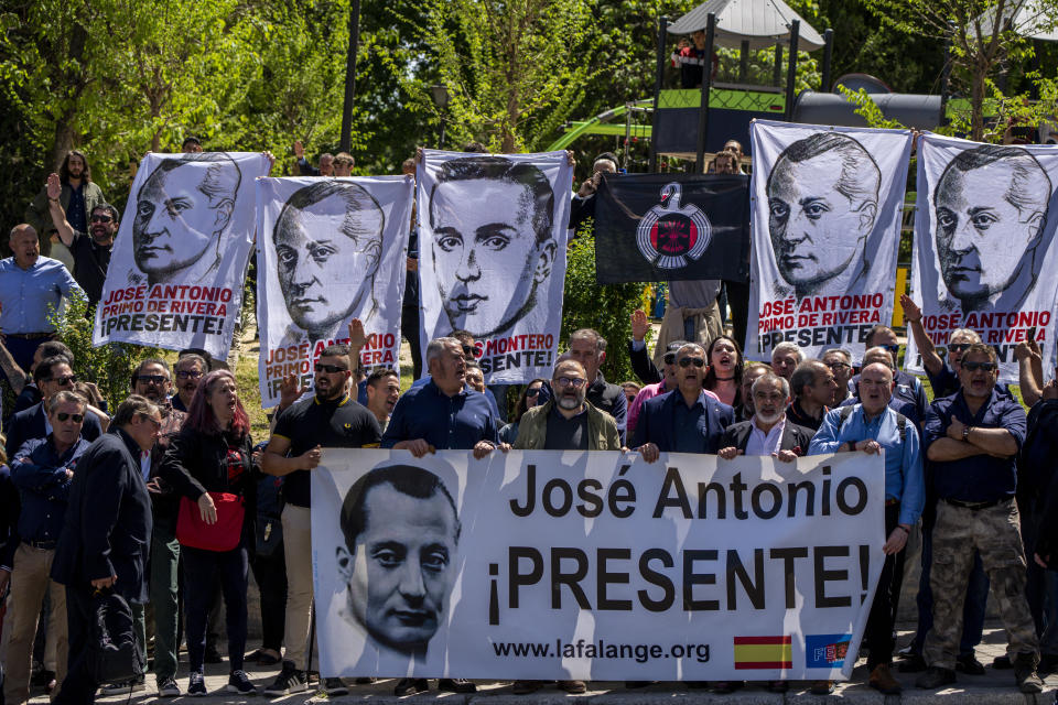 Dozens of people gather outside the San Isidro Cemetery in Madrid, Spain, Monday, April 24, 2023. The body of Jose Antonio Primo de Rivera, the founder of Spain’s fascist Falange movement, is exhumed from a Madrid mausoleum and transferred to a city cemetery. (AP Photo/Manu Fernandez)