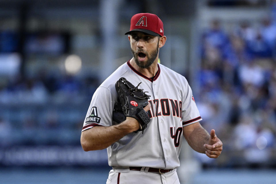 Arizona Diamondbacks starting pitcher Madison Bumgarner has words with home plate umpire John Tumpane after Trumpane appears to ask him to speed things up during the first inning of a baseball game Saturday, April 1, 2023, in Los Angeles. (AP Photo/Mark J. Terrill)