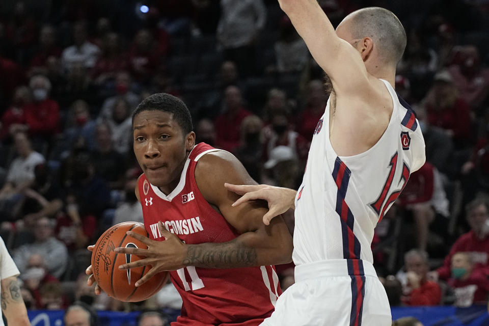 Wisconsin guard Lorne Bowman II drives on St. Mary's guard Tommy Kuhse (12) in the first half during an NCAA college basketball game at the Maui Invitational in Las Vegas, Wednesday, Nov. 24, 2021. (AP Photo/Rick Scuteri)