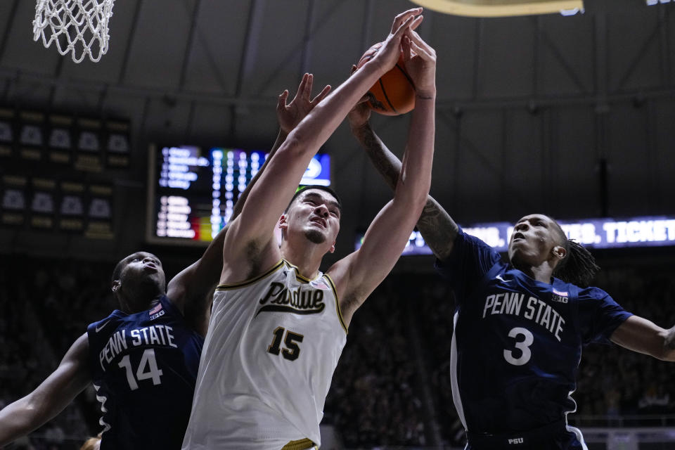 Purdue center Zach Edey (15) grabs a rebound between Penn State forward Demetrius Lilley (14) and guard Nick Kern Jr. (3) during the second half of an NCAA college basketball game in West Lafayette, Ind., Saturday, Jan. 13, 2024. (AP Photo/Michael Conroy)