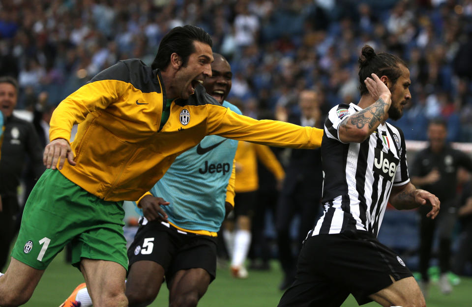 Juventus forward Pablo Daniel Osvaldo, right, celebrates after scoring with Juventus goalkeeper Gianluigi Buffon during an Italian Serie A soccer match between Roma and Juventus at Rome's Olympic stadium, Sunday, May 11, 2014. Juventus won 1 - 0. (AP Photo/Alessandra Tarantino)