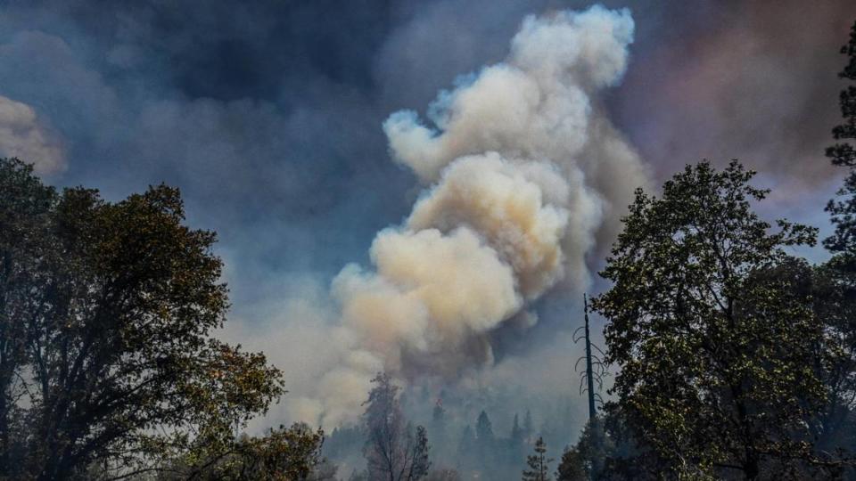 Plumes of smoke from the Oak Fire erupt from a mountainside as flames moves through the area east of Mariposa on Saturday, July 23, 2022.