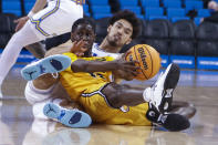 Long Beach State guard Jadon Jones, left, tries to keep the ball from UCLA guard Johnny Juzang during the first half of an NCAA college basketball game Thursday, Jan. 6, 2022, in Los Angeles. (AP Photo/Ringo H.W. Chiu)