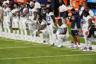 Members of the Tennessee Titans take part in the national anthem before an NFL football game against the Minnesota Vikings, Sunday, Sept. 27, 2020, in Minneapolis. The NFL says the Tennessee Titans and Minnesota Vikings are suspending in-person activities after the Titans had three players test positive for the coronavirus, along with five other personnel. The league says both clubs are working closely with the NFL and the players’ union on tracing contacts, more testing and monitoring developments. The Titans are scheduled to host the Pittsburgh Steelers on Sunday.(AP Photo/Jim Mone)