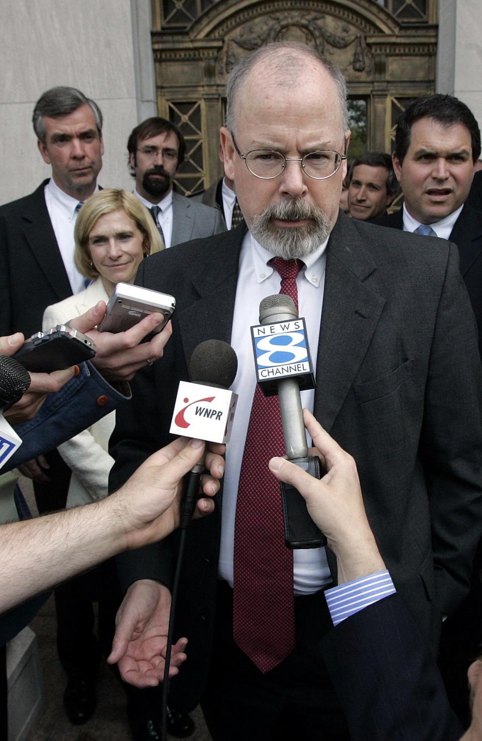 In this April 25, 2006, file photo, John Durham speaks to reporters on the steps of U.S. District Court in New Haven, Conn.