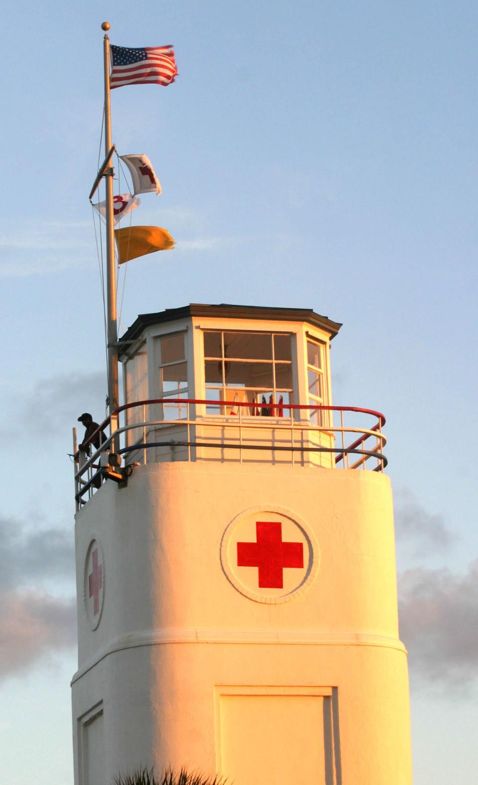 In this file photo, a lifeguard stands watch on the familiar tower at the American Red Cross Volunteer Lifesaving Corps headquarters at the foot of Beach Boulevard in Jacksonville Beach. The Red Cross logos and signage will soon be removed at the city takes ownership of the building.