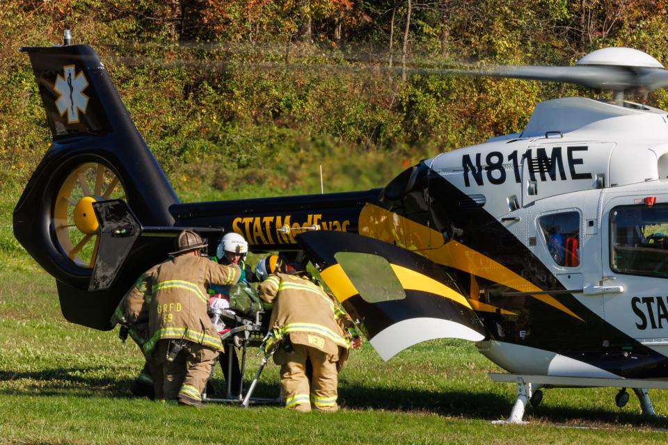 Crews carry a man to a medical helicopter after he was burned by gasoline while burning tree stump on the 3700 block of Sticks Road, Thursday, Oct. 19, 2023, in Codorus Township. The man was airlifted to the Johns Hopkins Bayview burn center in Baltimore.
