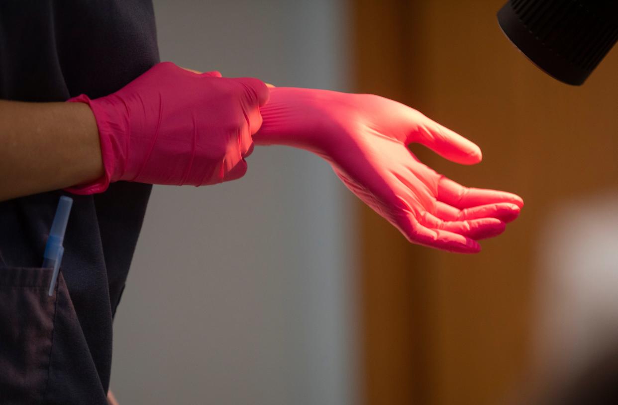 A doctor at the Women's Med Center in Kettering, near Dayton, Ohio, puts gloves on to prepare for an abortion in late June.