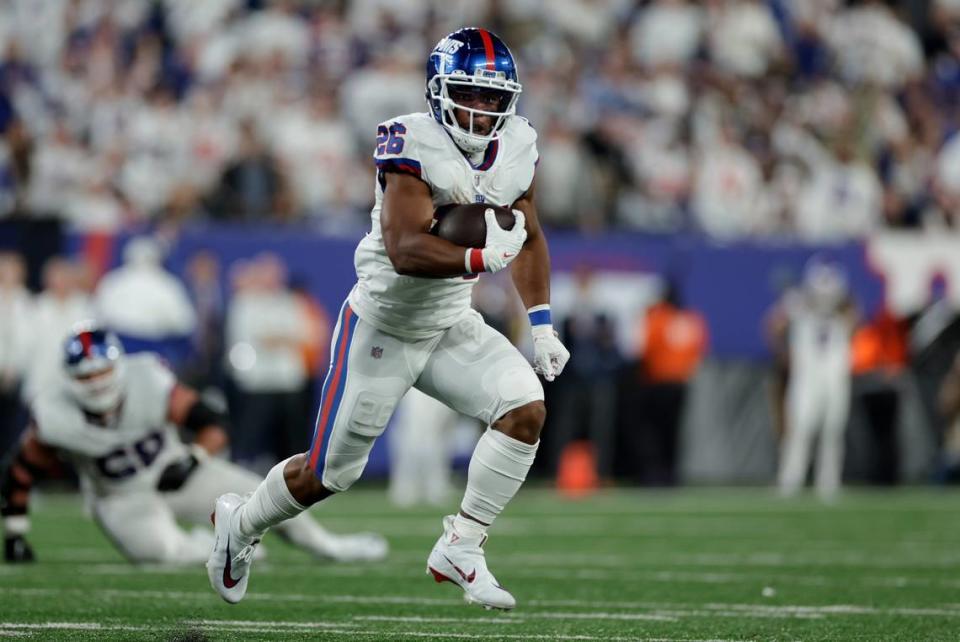 New York Giants running back Saquon Barkley (26) runs for a touchdown against the Dallas Cowboys during the third quarter of an NFL football game, Monday, Sept. 26, 2022, in East Rutherford, N.J. (AP Photo/Adam Hunger)