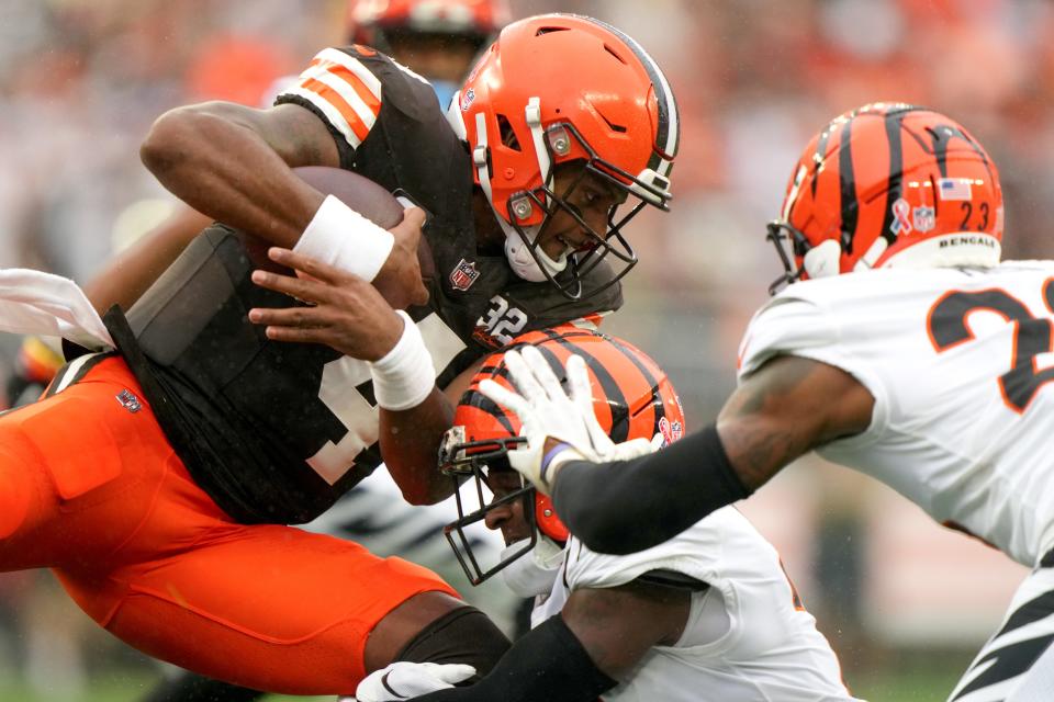 Cleveland Browns quarterback <a class="link " href="https://sports.yahoo.com/nfl/players/30125" data-i13n="sec:content-canvas;subsec:anchor_text;elm:context_link" data-ylk="slk:Deshaun Watson;sec:content-canvas;subsec:anchor_text;elm:context_link;itc:0">Deshaun Watson</a> (4) runs for a first down as Cincinnati Bengals cornerback <a class="link " href="https://sports.yahoo.com/nfl/players/29510" data-i13n="sec:content-canvas;subsec:anchor_text;elm:context_link" data-ylk="slk:Mike Hilton;sec:content-canvas;subsec:anchor_text;elm:context_link;itc:0">Mike Hilton</a> (21) makes the tackle in the first quarter of an NFL football game between the Cincinnati Bengals and Cleveland Browns, Sunday, Sept. 10, 2023, at Cleveland Browns Stadium in Cleveland.